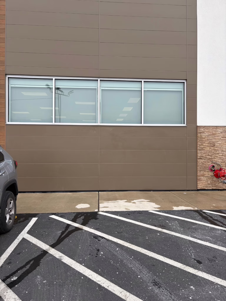 Powder Coated Metal Building Surface after Yellow Spray Paint Graffiti has been removed